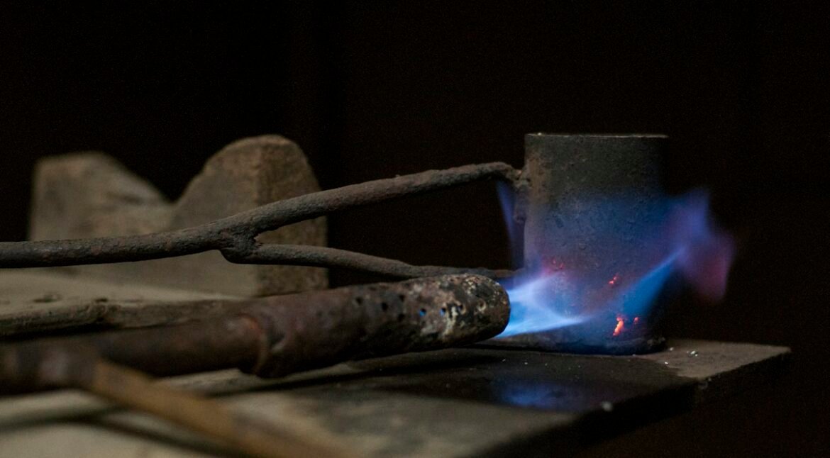 Blue torch flame on metal