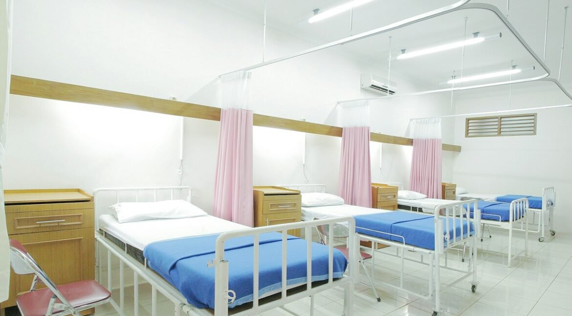 Empty hospital bed in a ward