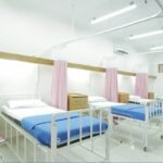 Empty hospital bed in a ward