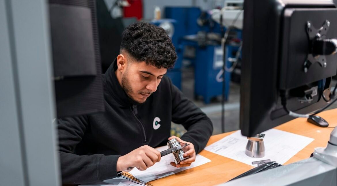 Inspector measuring a metal component