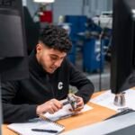 Inspector measuring a metal component